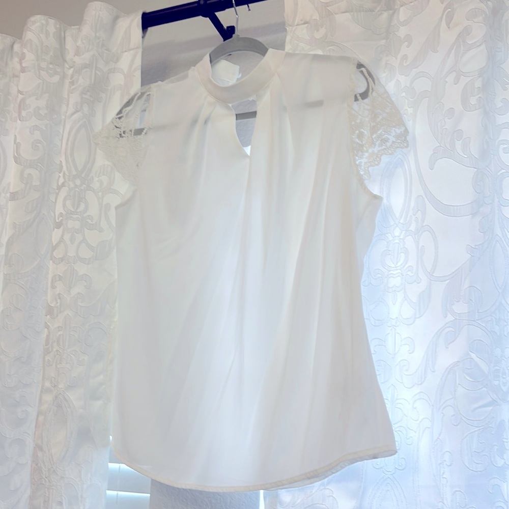 White woman’s blouse short sleeved- keyhole neck and lace cap sleeved